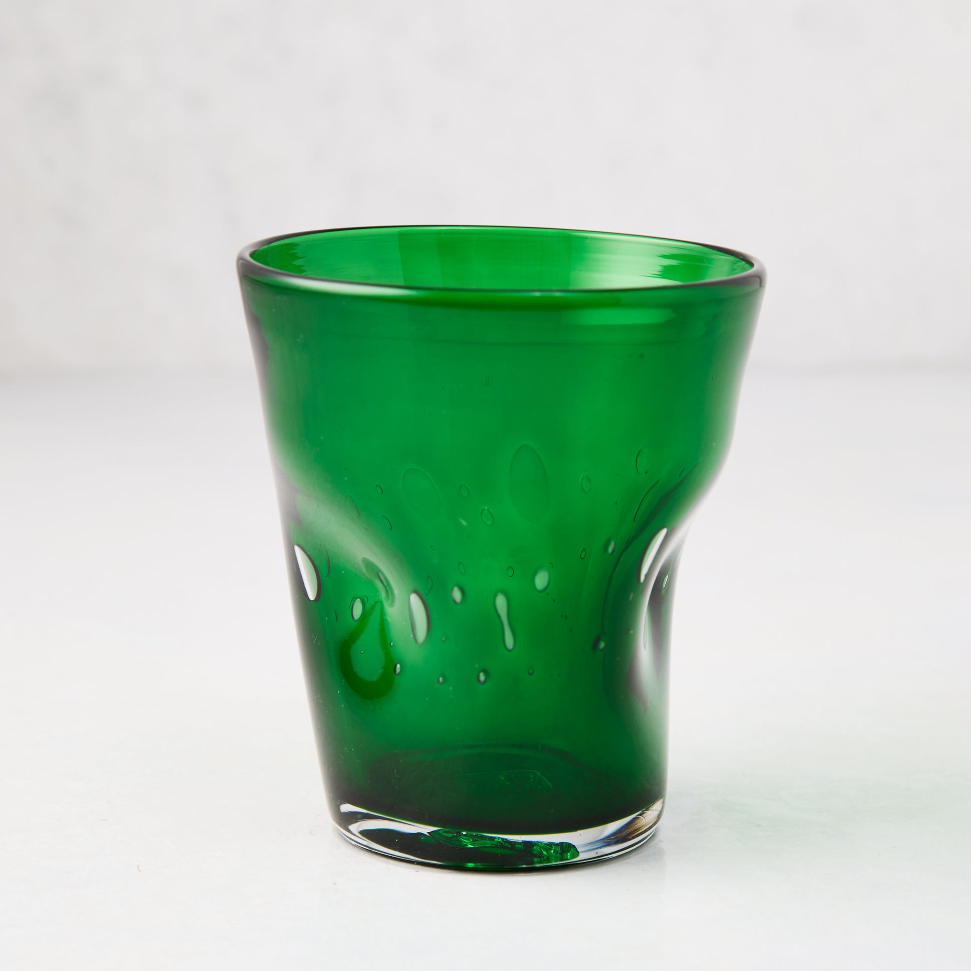Dark green Henri mouth-blown glass, 8 oz., with unique imperfections and air bubbles.