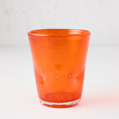 Dark orange Henri mouth-blown glass, 8 oz, with unique air bubbles and slight asymmetry.