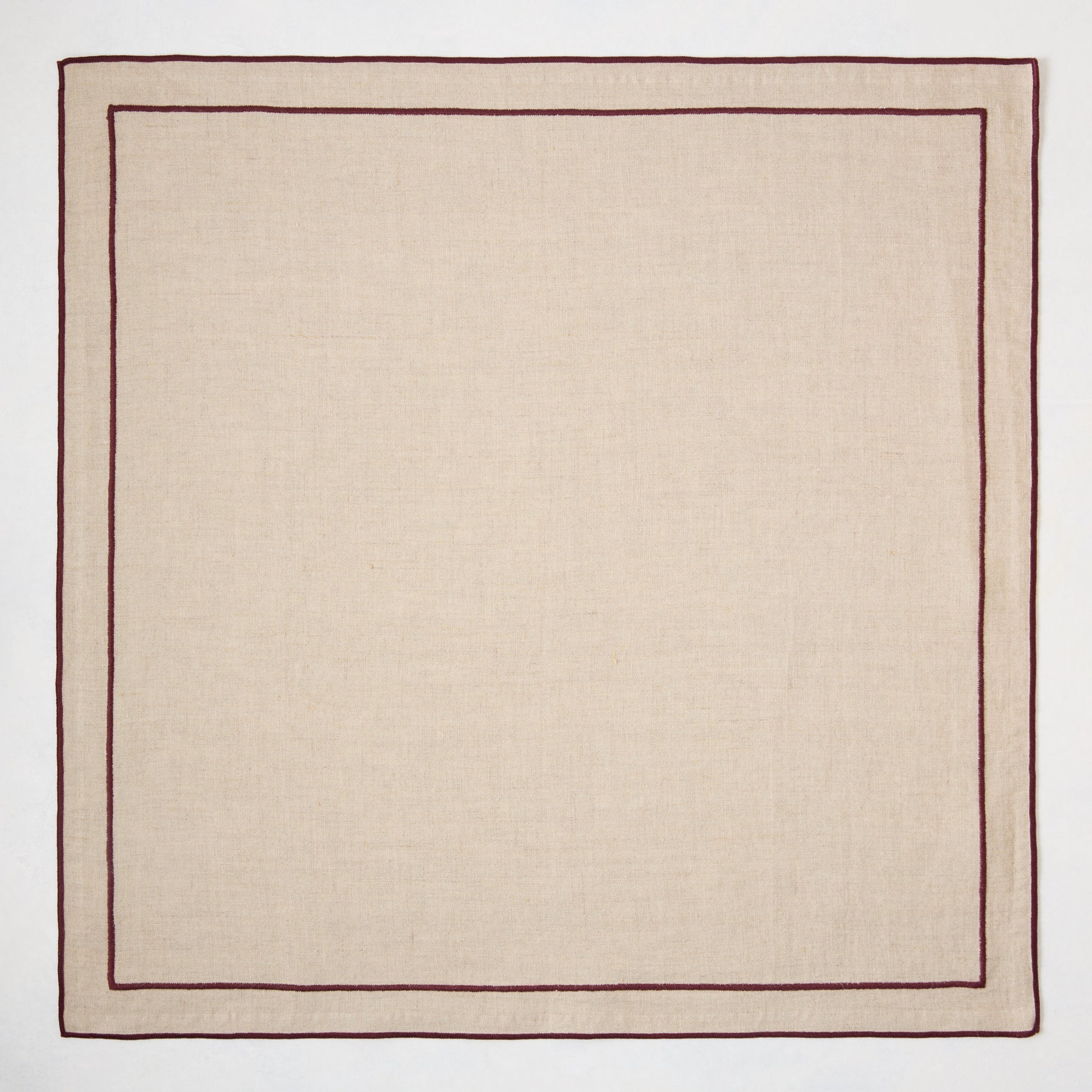 Beige natural cotton napkin with dark plum double-line embroidered border.