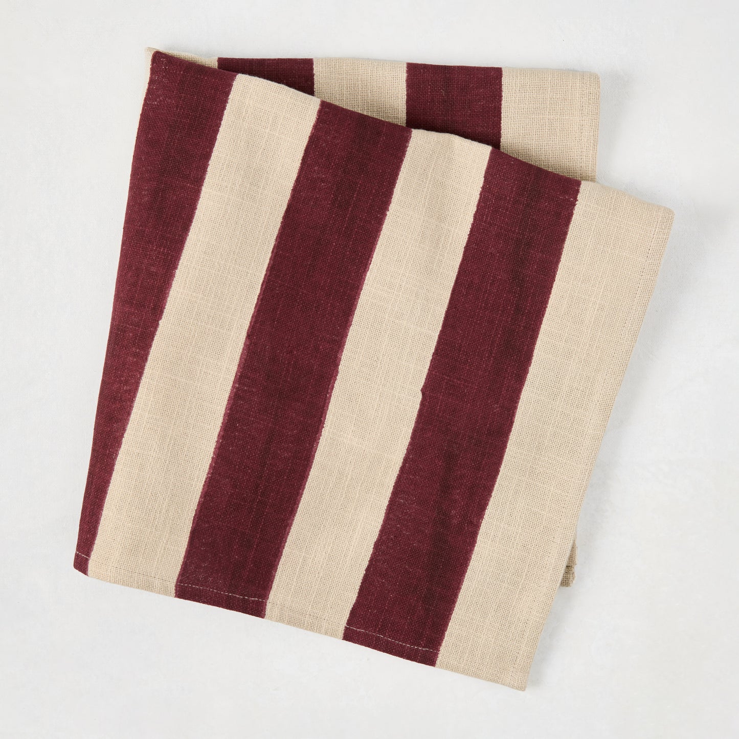 Dark Plum Hampton Stripe Natural Cotton Napkin, folded, with wide dark purple stripes on a khaki base.