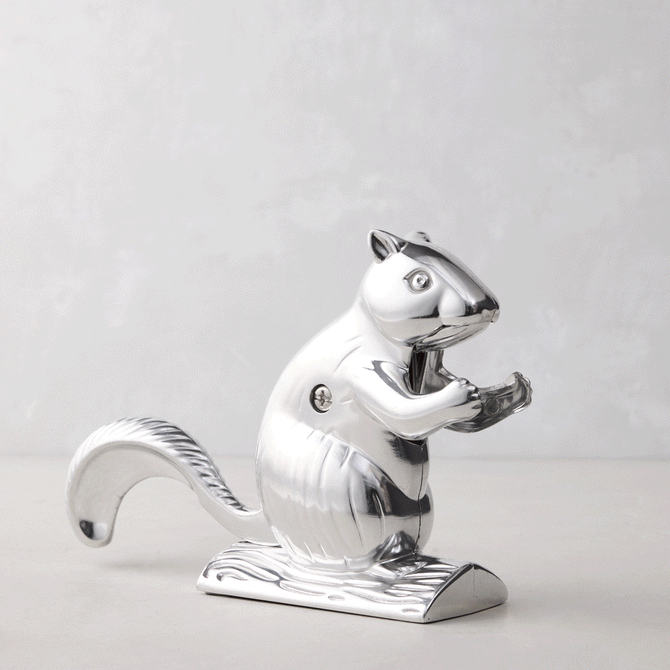 Shiny silver metal squirrel nutcracker, "Davy Crackit" design, holding a nut, on a light background.