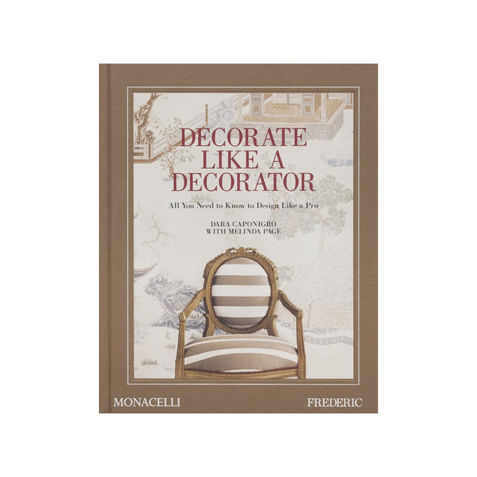 Hardcover book "Decorate Like a Decorator" with a brown spine and a cover featuring a striped chair against a scenic wallpaper.