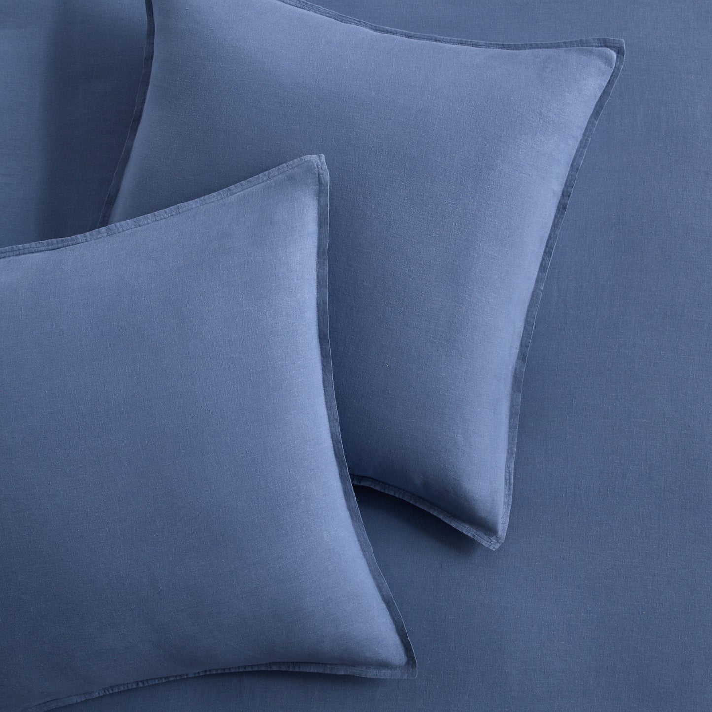 Set of two denim blue European washed linen euro shams with a soft, textured fabric finish.