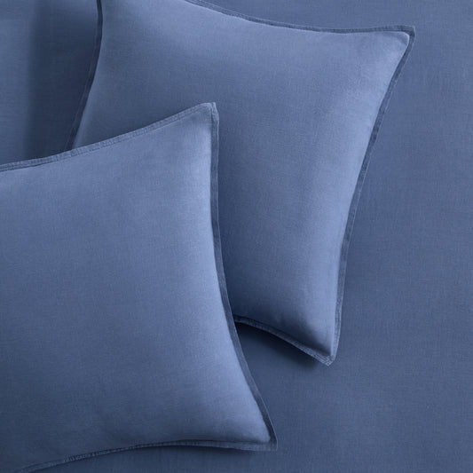 Set of two denim blue European washed linen euro shams with a soft, textured fabric finish.