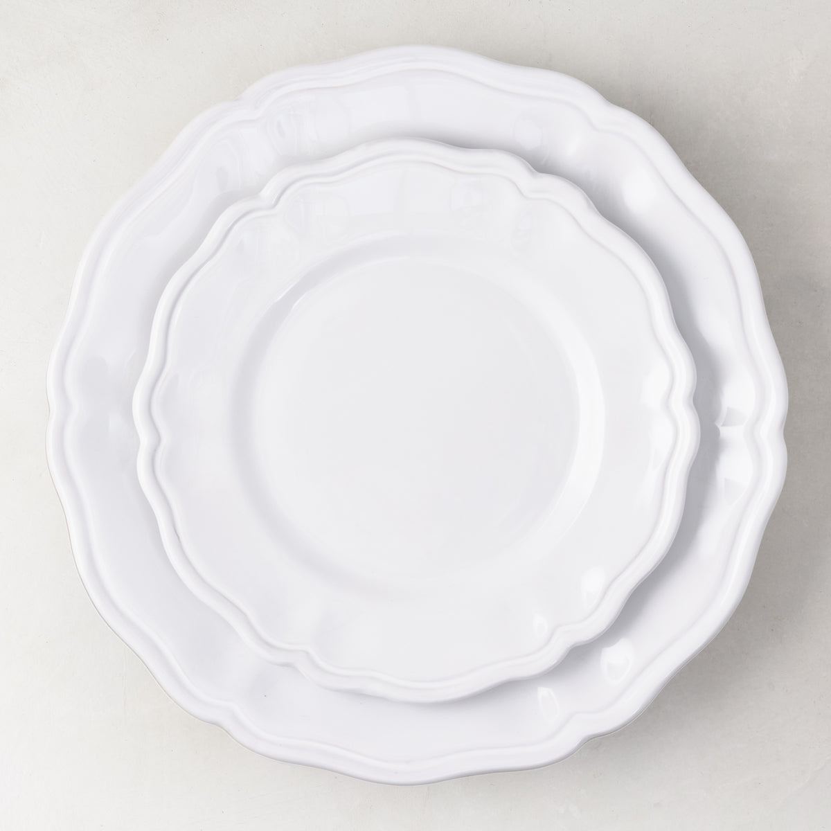 Handmade white ceramic dinner plate with scalloped edges, 11-inch diameter, Italian-style painted finish.