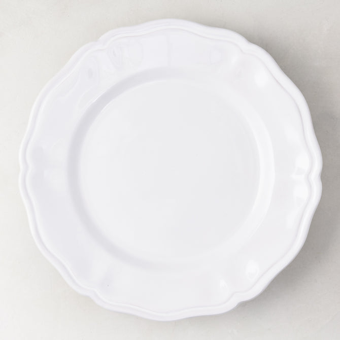 11-inch white ceramic dinner plate with a scalloped edge, handmade in Italy.