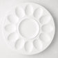 White ceramic Deviled Egg Serving Platter, 11"Dia, with 12 egg indentations and a center dip well.