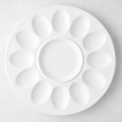 White ceramic Deviled Egg Serving Platter, 11"Dia, with 12 egg indentations and a center dip well.