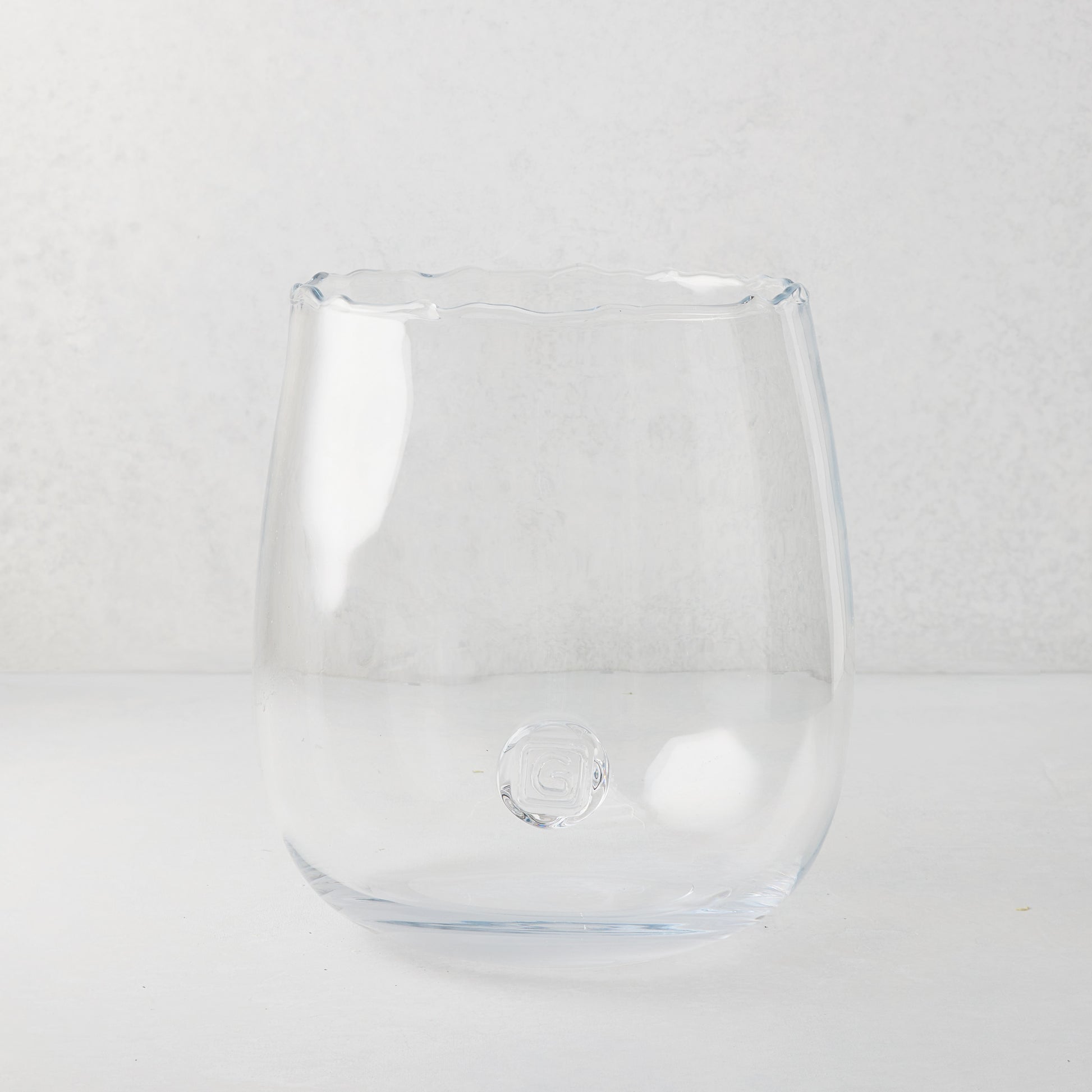 Clear, large Diana Scissor-Cut Vase with a rounded base and subtle scissor-cut edge.