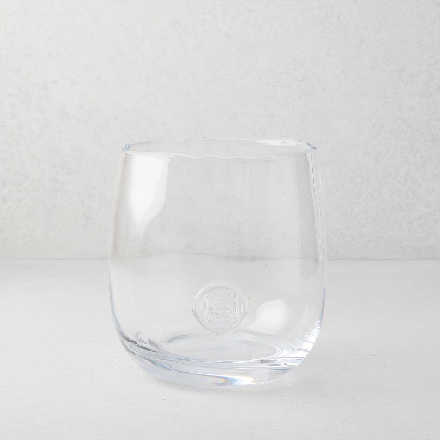Clear mouth-blown glass Diana Small Scissor-Cut Vase with rounded base and subtle logo.
