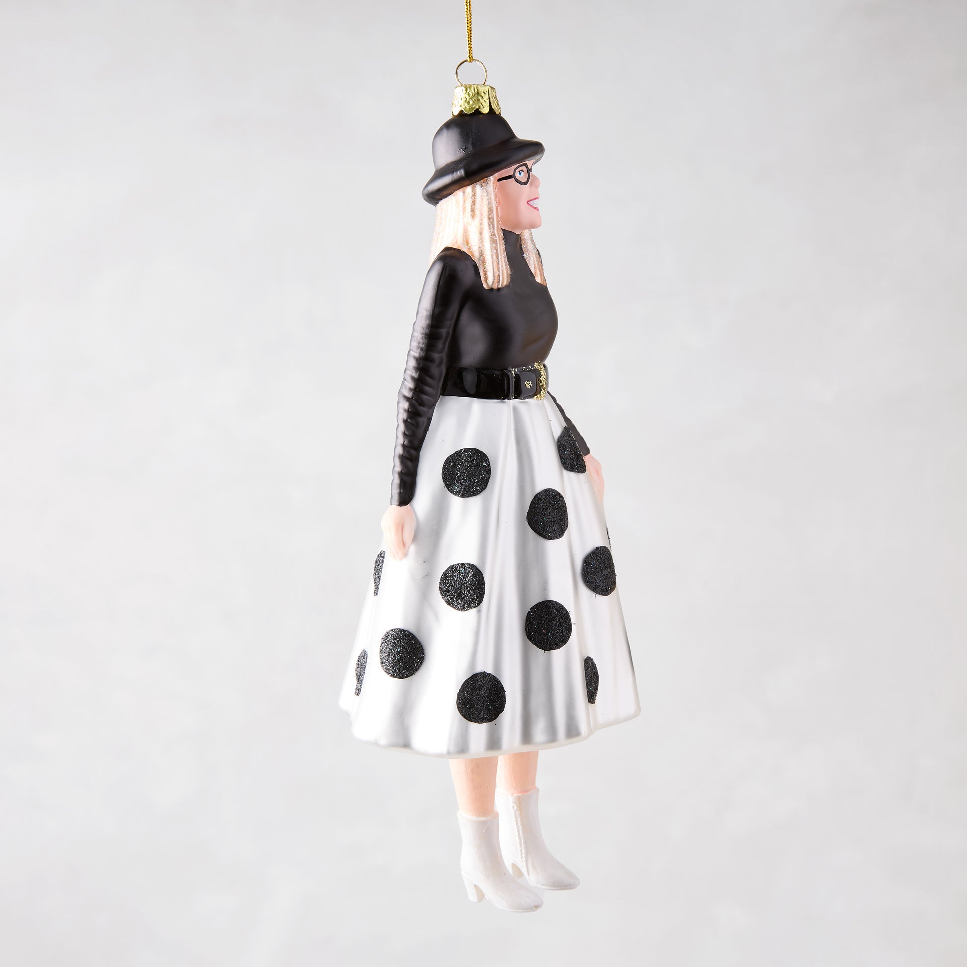 Diane Keaton Christmas tree ornament, black hat, glasses, black top, white polka dot skirt, white boots.