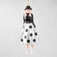 Diane Keaton Christmas tree ornament, black hat, glasses, black top, white polka dot skirt, white boots.