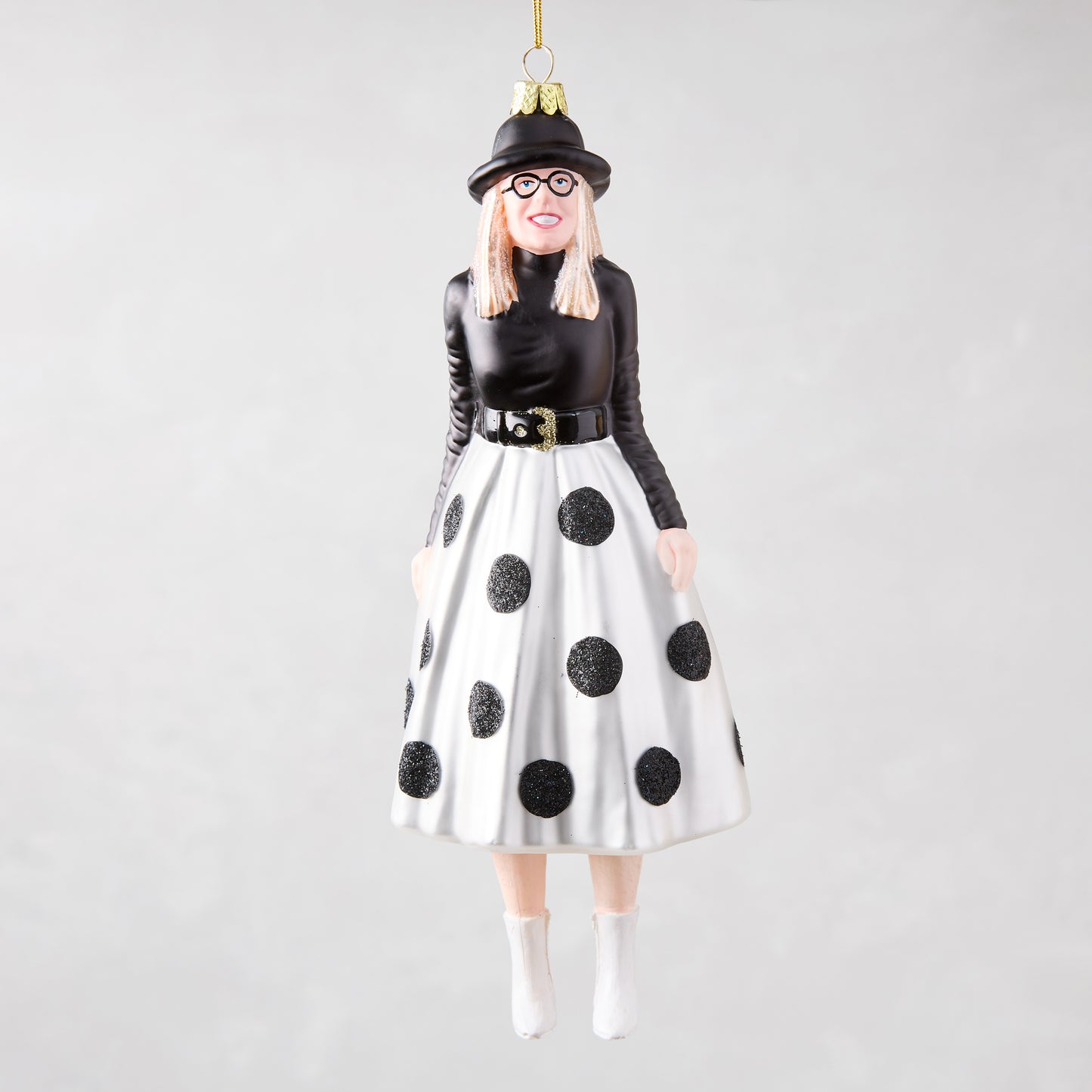 Diane Keaton Christmas tree ornament, black hat, glasses, black top, white polka dot skirt, white boots.