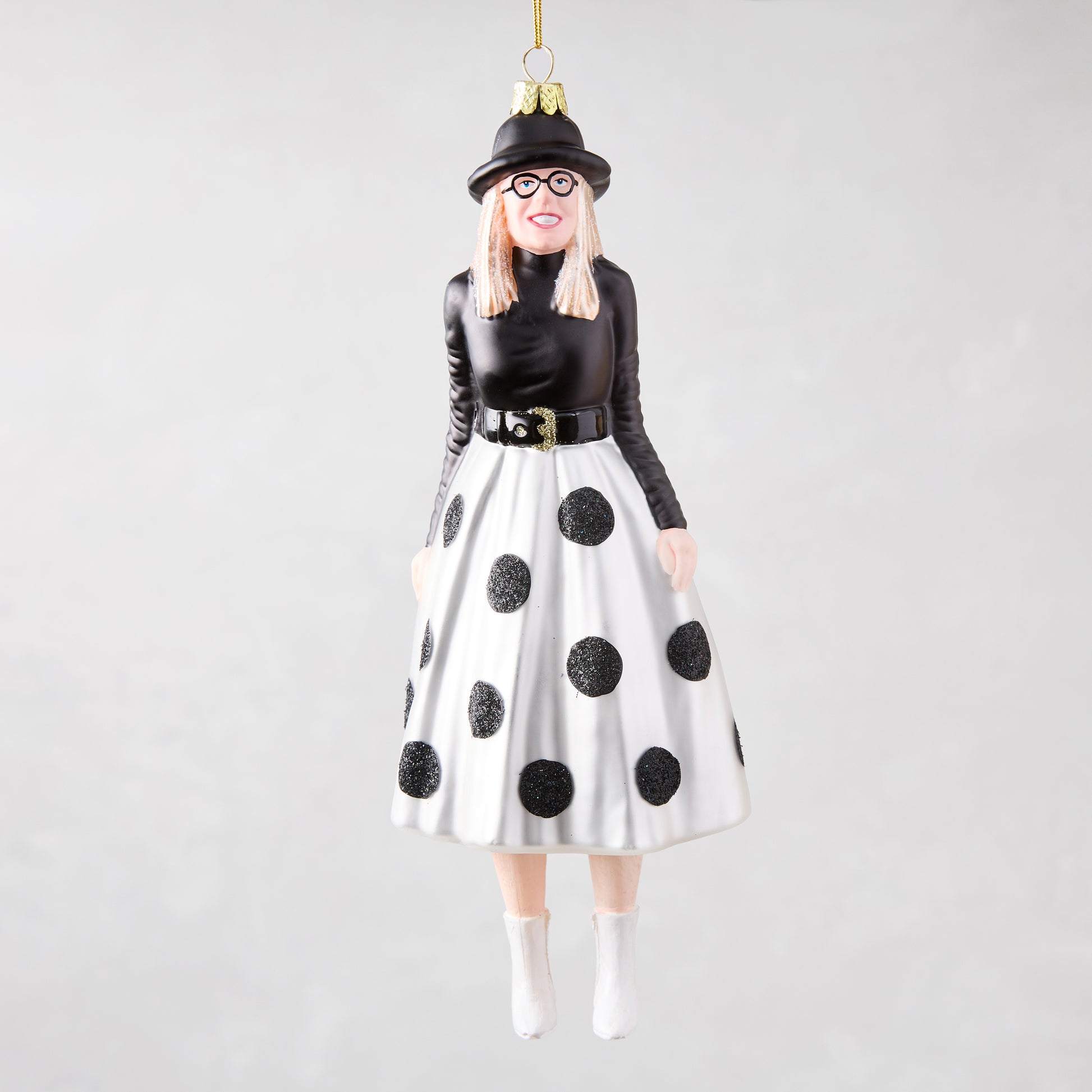 Diane Keaton Christmas tree ornament, black hat, glasses, black top, white polka dot skirt, white boots.