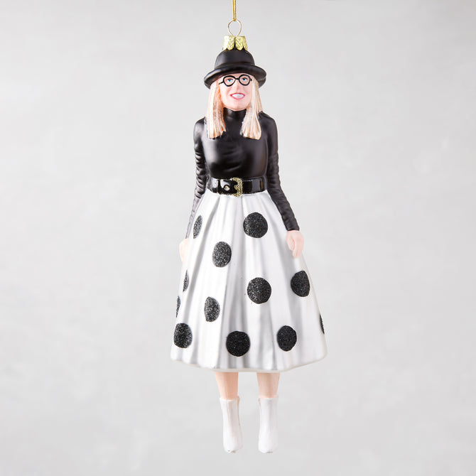 Diane Keaton Christmas tree ornament, black hat, glasses, black top, white polka dot skirt, white boots.