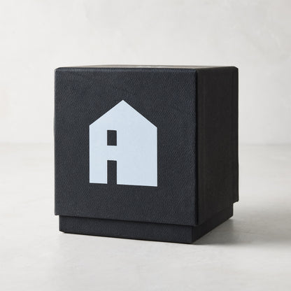 Diane Keaton "HOUSE" scented candle in a sleek black gift box with a white house logo.