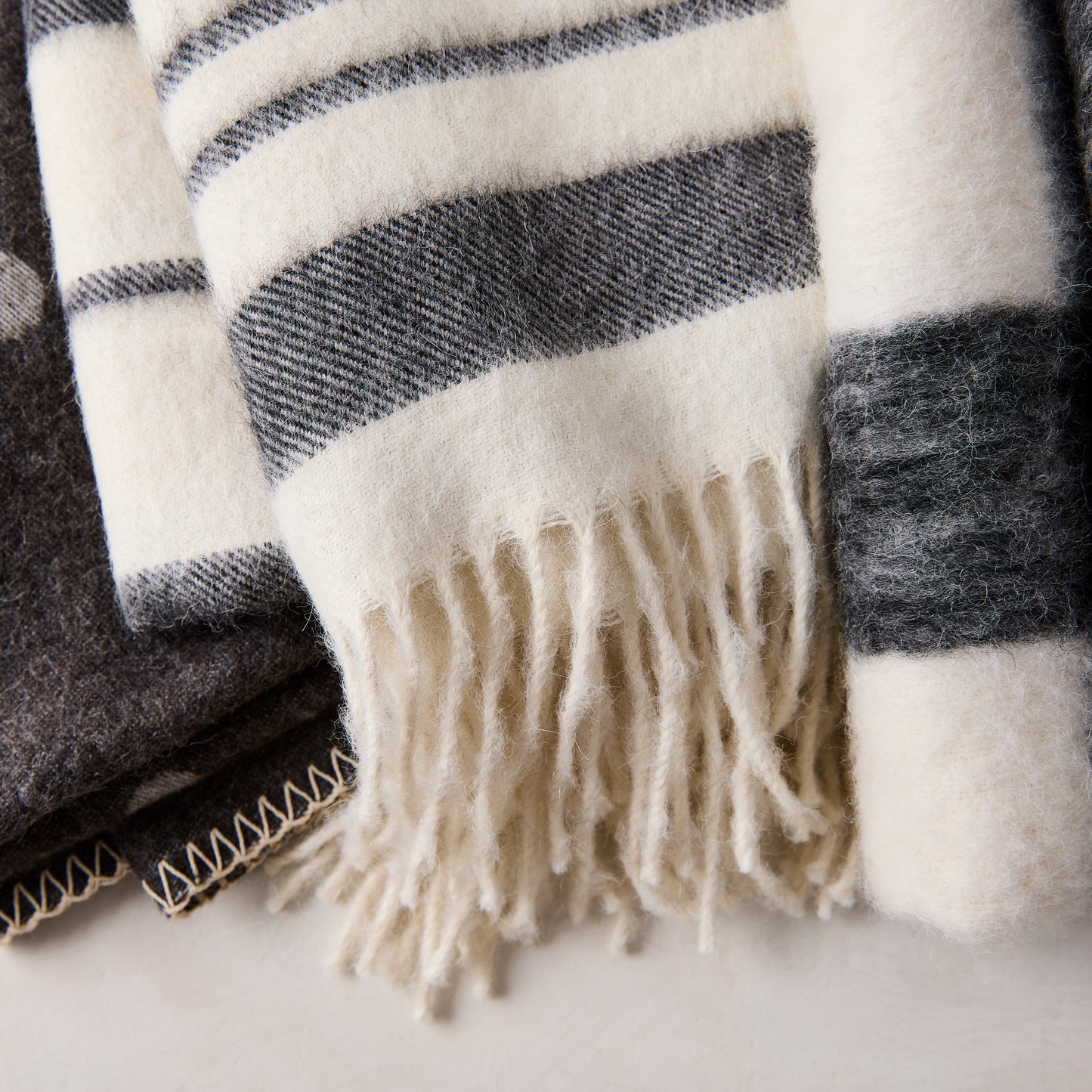 Diane Keaton x Hudson Grace black and white striped baby alpaca throw blanket with fringe.