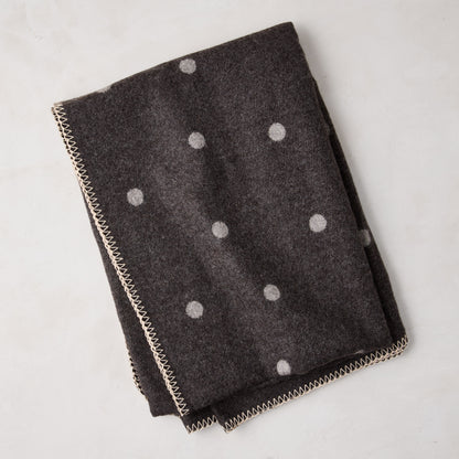 Diane Keaton + Hudson Grace grey polka dot baby alpaca throw blanket with decorative stitching.