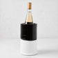 Diane Keaton + Hudson Grace black and white dipped ceramic wine chiller with a bottle of white wine.