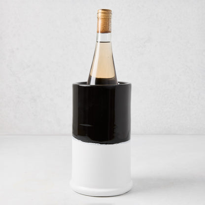 Diane Keaton + Hudson Grace black and white dipped ceramic wine chiller with a bottle of white wine.