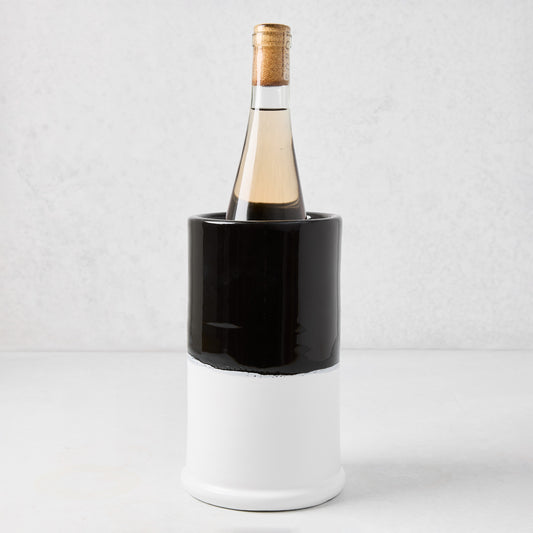 Diane Keaton + Hudson Grace black and white dipped ceramic wine chiller with a bottle of white wine.