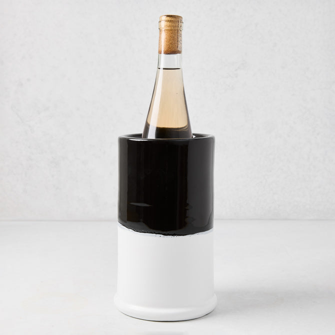 Diane Keaton + Hudson Grace black and white dipped ceramic wine chiller with a bottle of white wine.