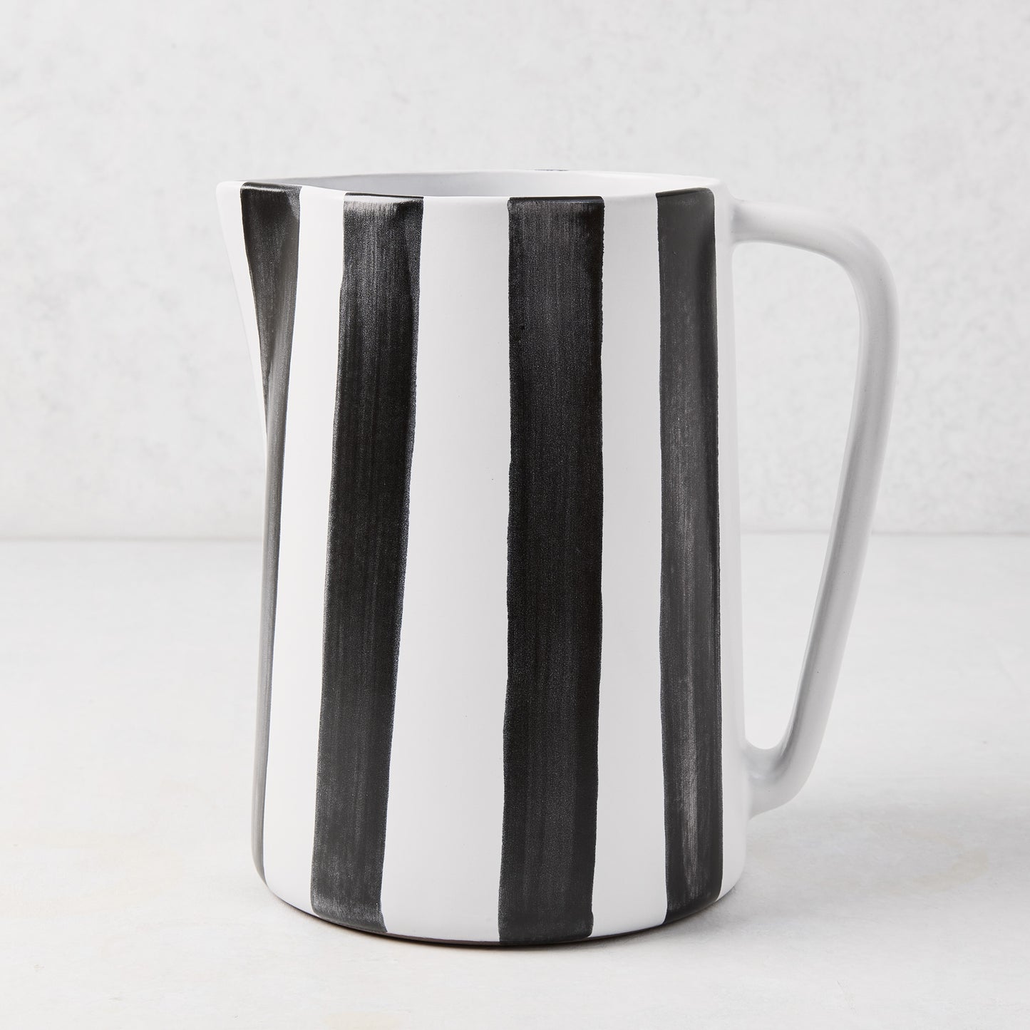 Diane Keaton + Hudson Grace black and white striped ceramic pitcher with geometric handle.