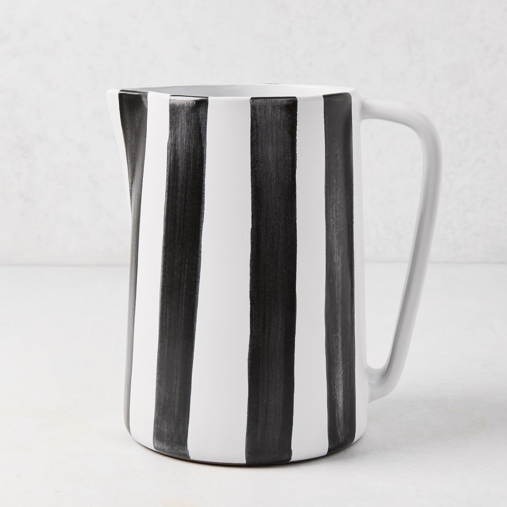 Diane Keaton + Hudson Grace black and white striped ceramic pitcher with geometric handle.