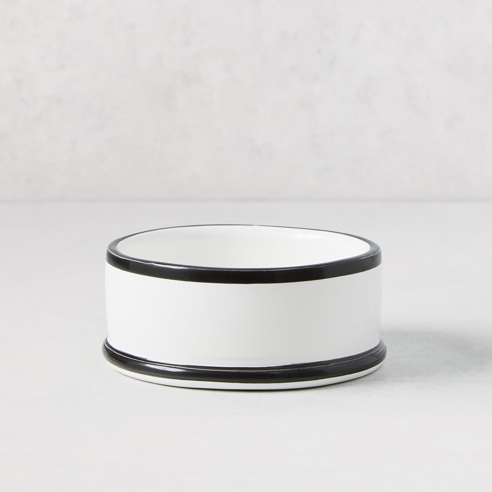 Diane Keaton + Hudson Grace white ceramic wine coaster with hand-painted black lines.