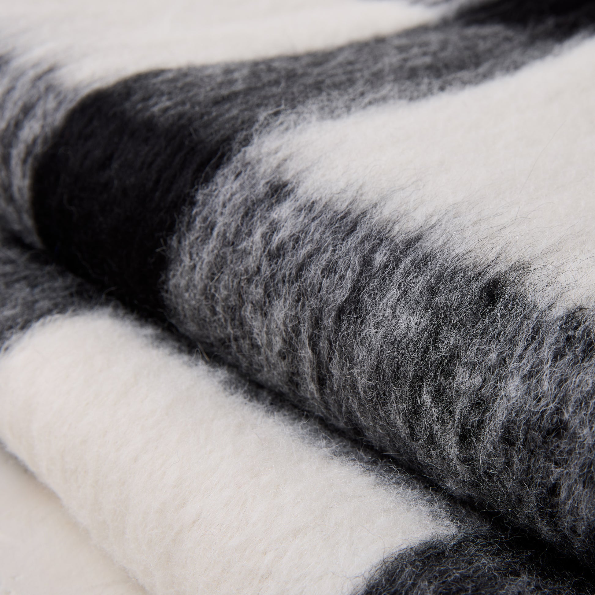 Diane Keaton + Hudson Grace black and white buffalo check baby alpaca throw blanket, folded.