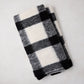 Diane Keaton + Hudson Grace black and white buffalo check baby alpaca throw blanket, folded.