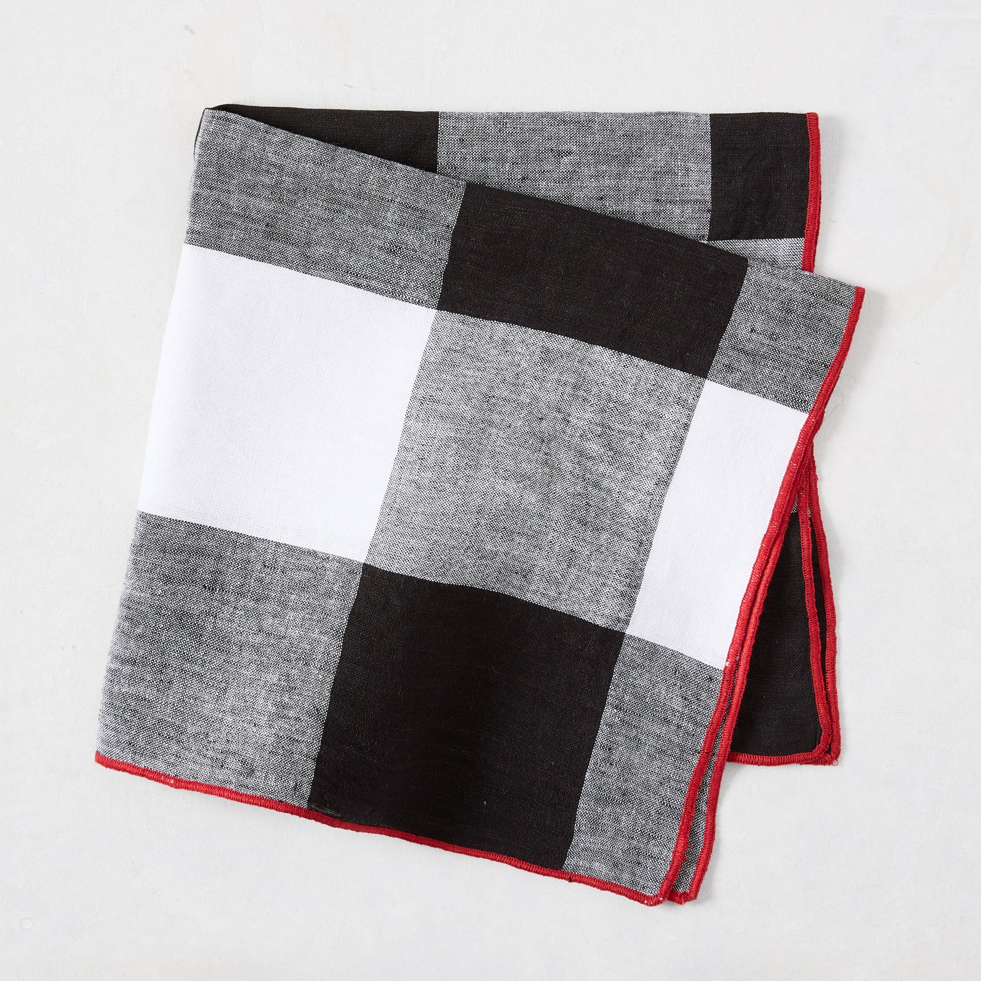 Diane Keaton + Hudson Grace black buffalo check cotton linen napkin with red border.