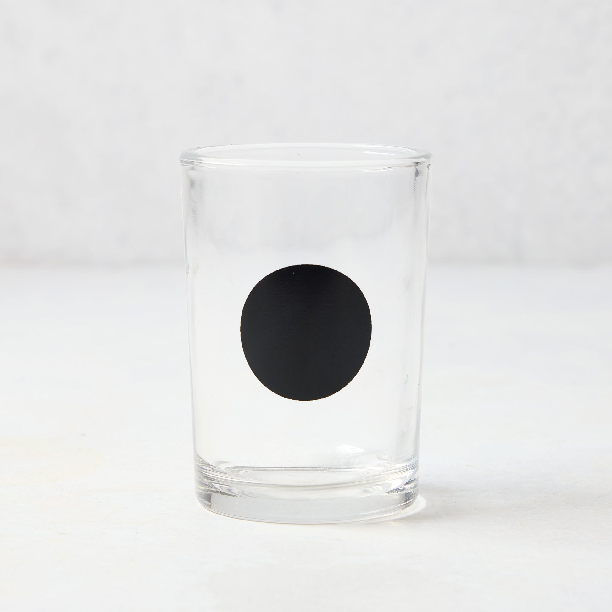 Diane Keaton + Hudson Grace clear glass everyday wine glass with a bold black dot.