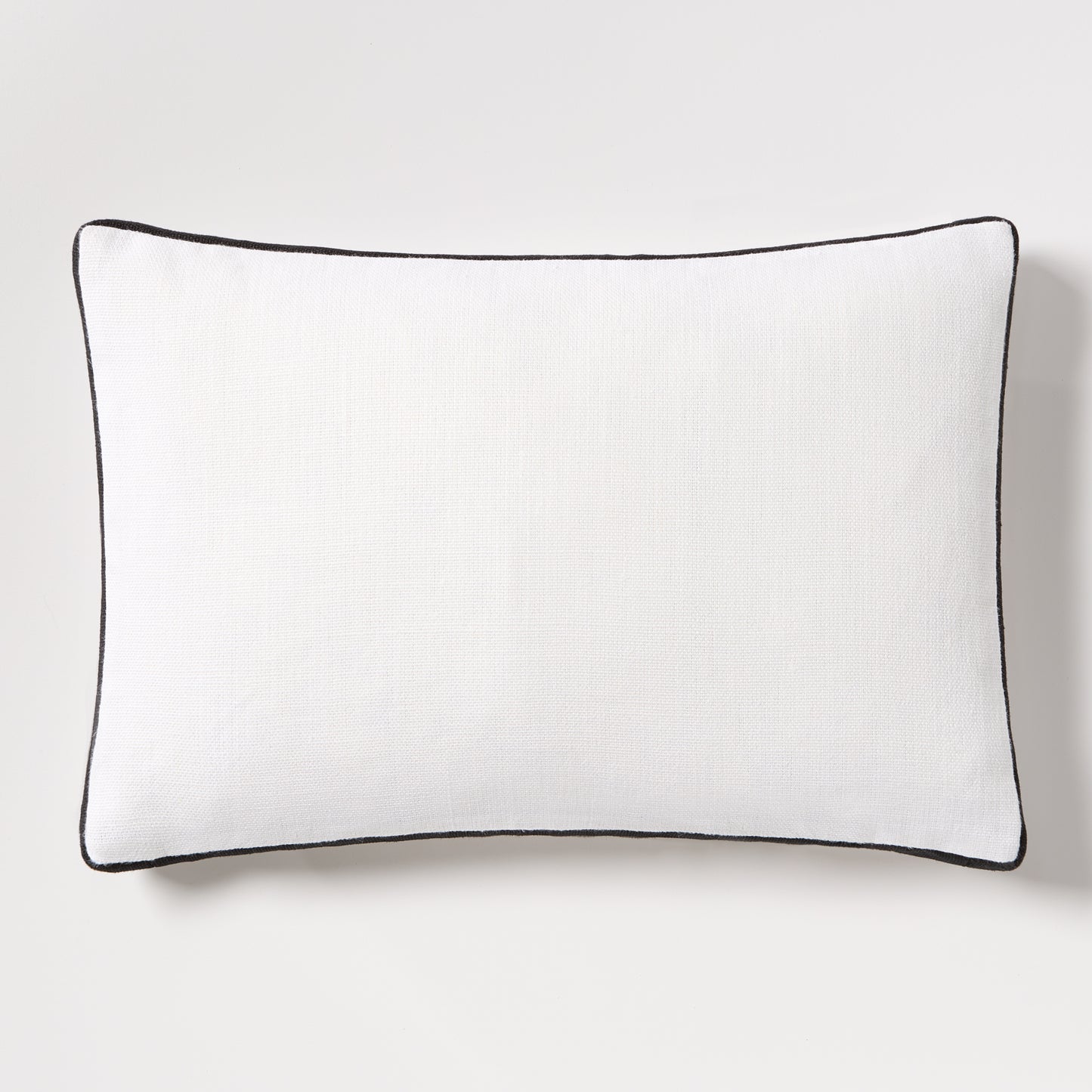 Diane Keaton + Hudson Grace white linen lumbar pillow with black gusseted trim.