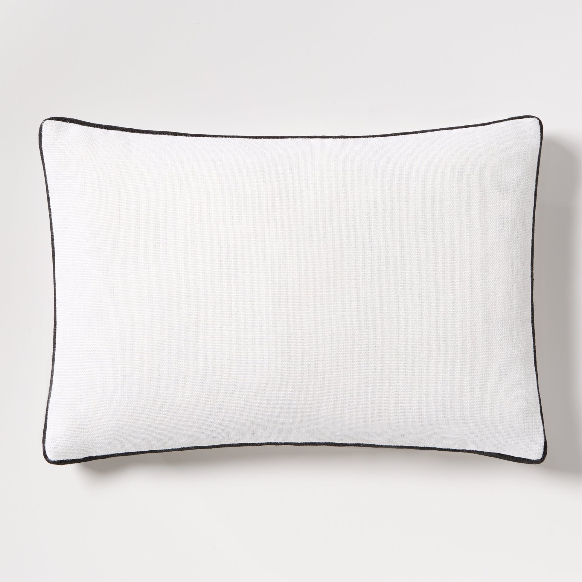 Diane Keaton + Hudson Grace white linen lumbar pillow with black gusseted trim.