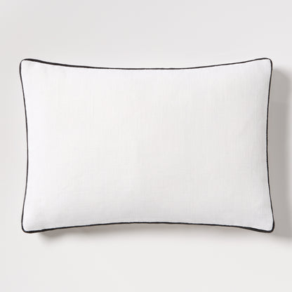 Diane Keaton + Hudson Grace white linen lumbar pillow with black gusseted trim.