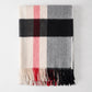 Diane Keaton + Hudson Grace black, red, and cream plaid alpaca throw blanket with fringe.