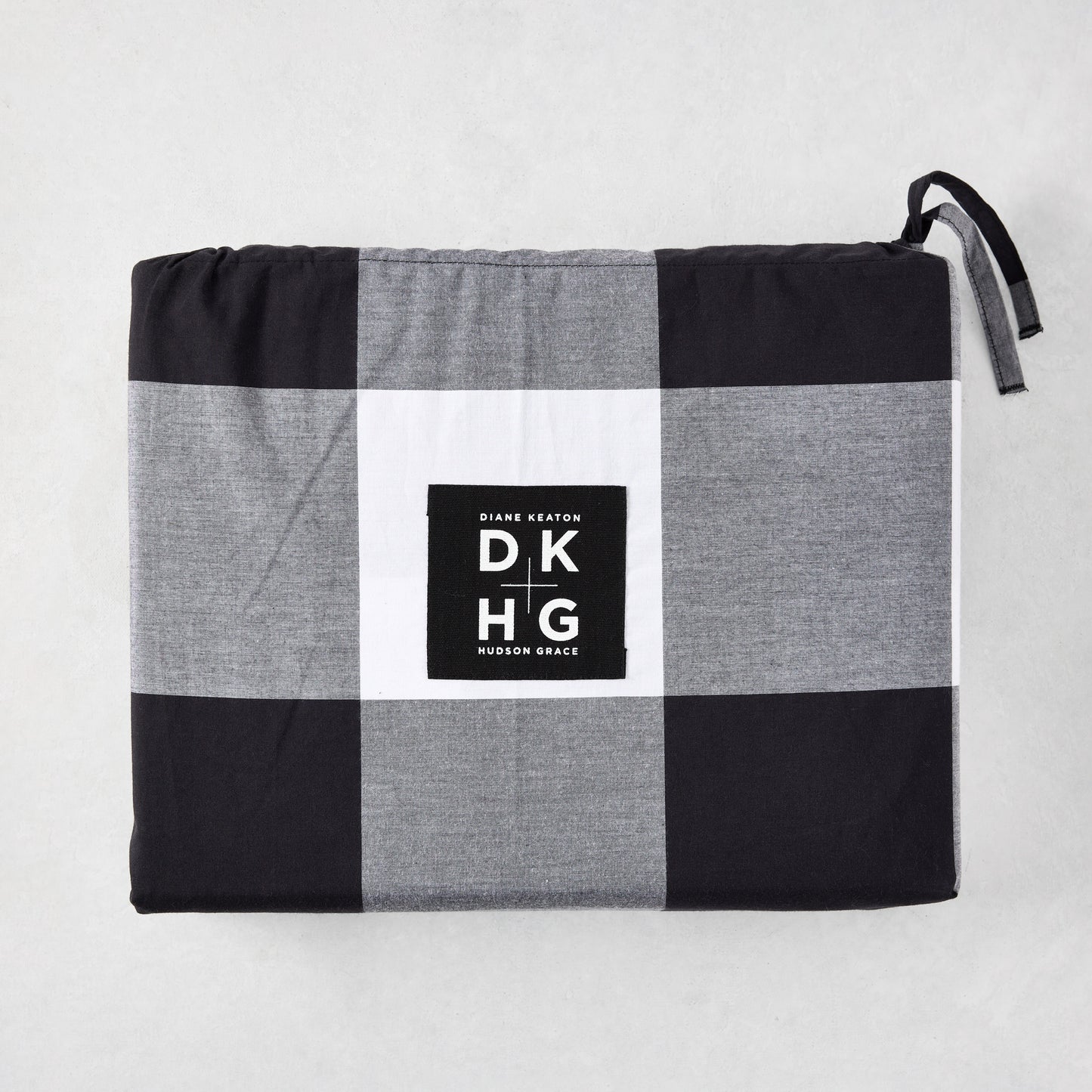 Diane Keaton + Hudson Grace black and white buffalo check percale duvet and shams set, folded.