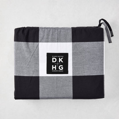Diane Keaton + Hudson Grace black and white buffalo check percale duvet and shams set, folded.