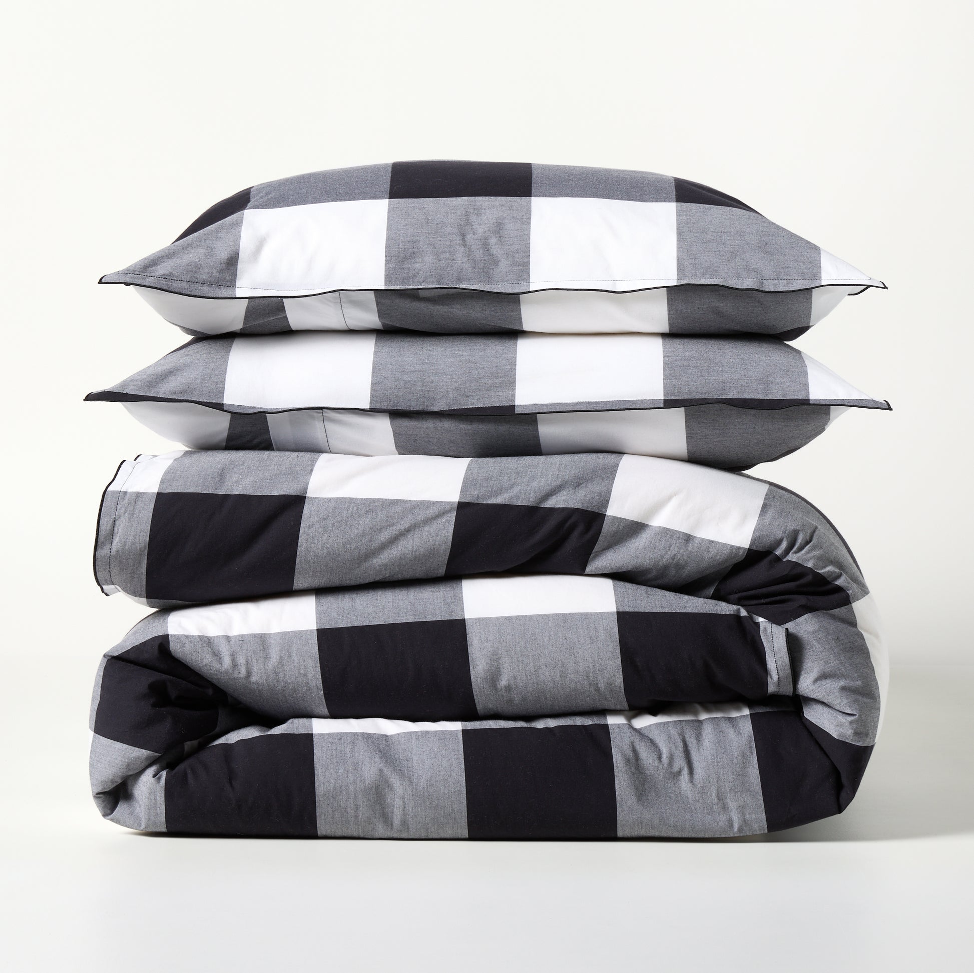 Diane Keaton + Hudson Grace black and white buffalo check percale duvet and shams set, folded.