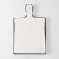 Diane Keaton + Hudson Grace ceramic cheese board with black trim and rounded handle.
