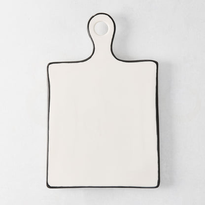 Diane Keaton + Hudson Grace ceramic cheese board with black trim and rounded handle.