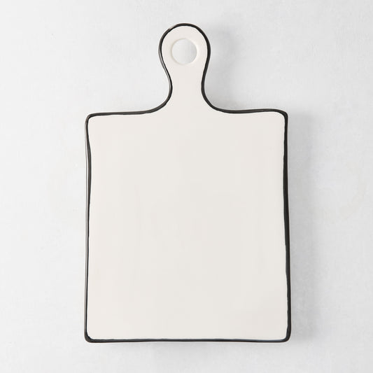 Diane Keaton + Hudson Grace ceramic cheese board with black trim and rounded handle.