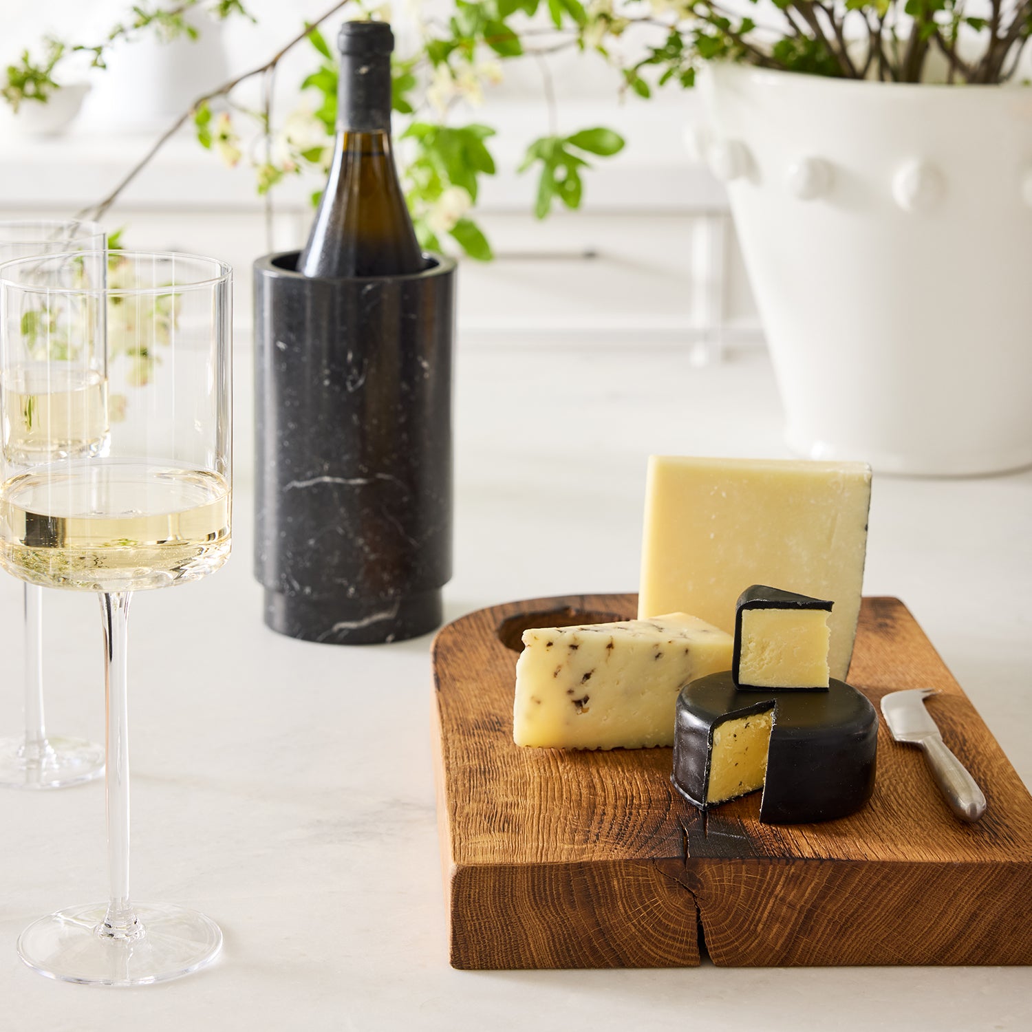 Diane Keaton + Hudson Grace Deco black marble wine chiller with a bottle, wine glasses, and cheese board.