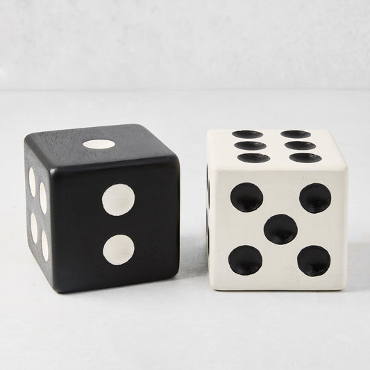 Two Diane Keaton + Hudson Grace decorative carved mango wood dice: one black with white dots, one white with black dots.