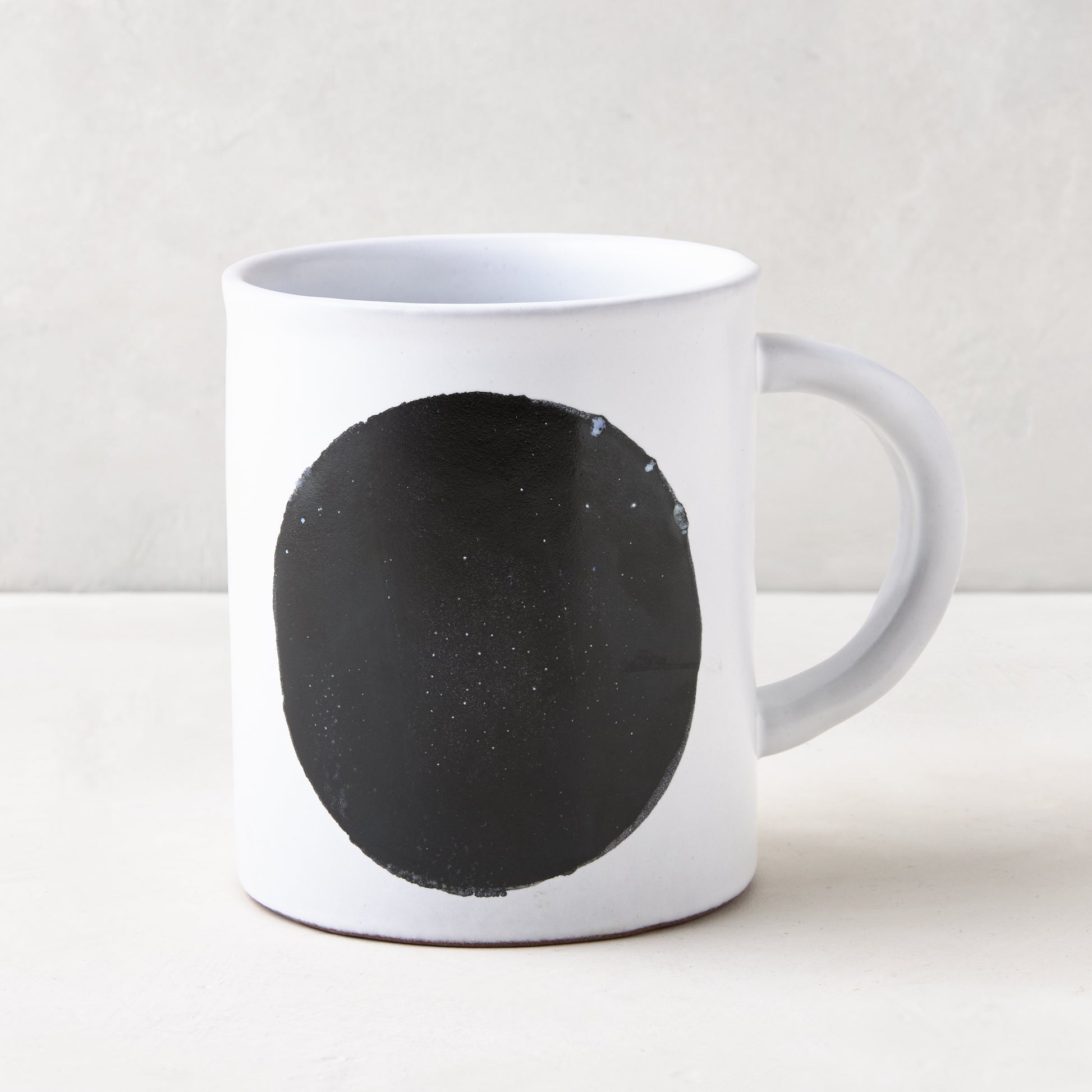 Diane Keaton + Hudson Grace Domino Dot Stoneware Mug, white with a large black circle design.