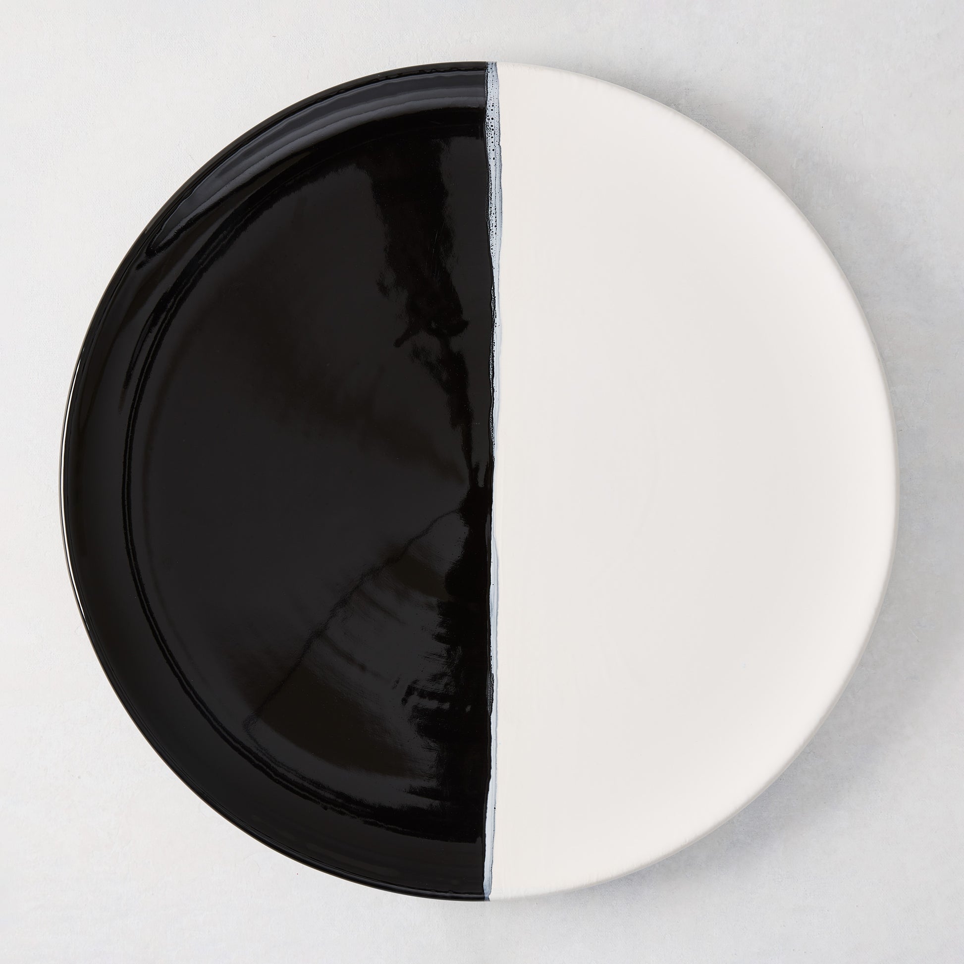 Diane Keaton + Hudson Grace Domino Half-Dipped Round Serving Platter, black and white ceramic.