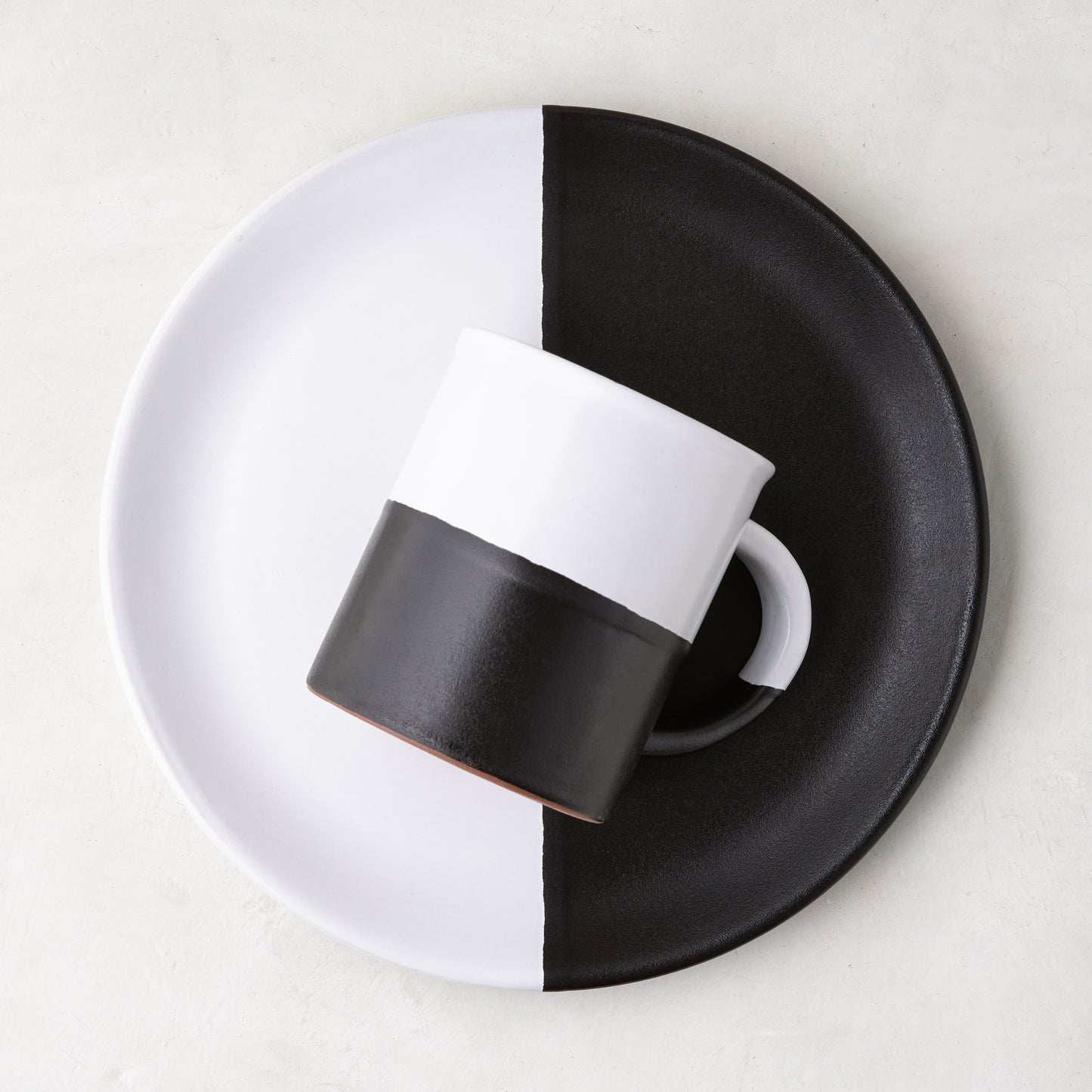 Diane Keaton + Hudson Grace Domino half-dipped black and white stoneware salad plate with matching mug.