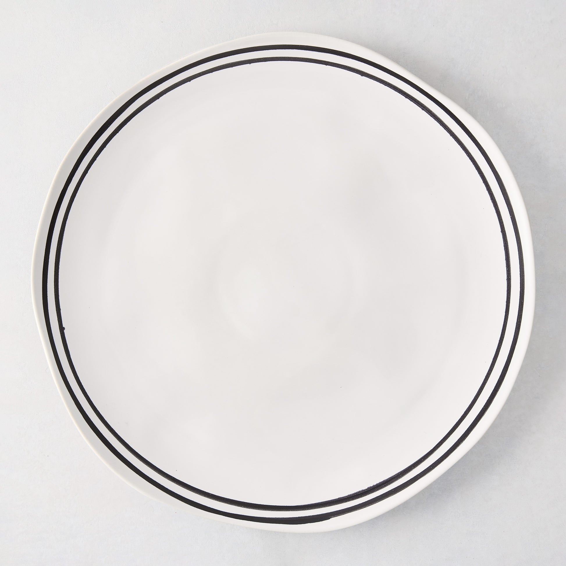 Diane Keaton + Hudson Grace Draft white stoneware dinner plate with hand-painted black double stripes.