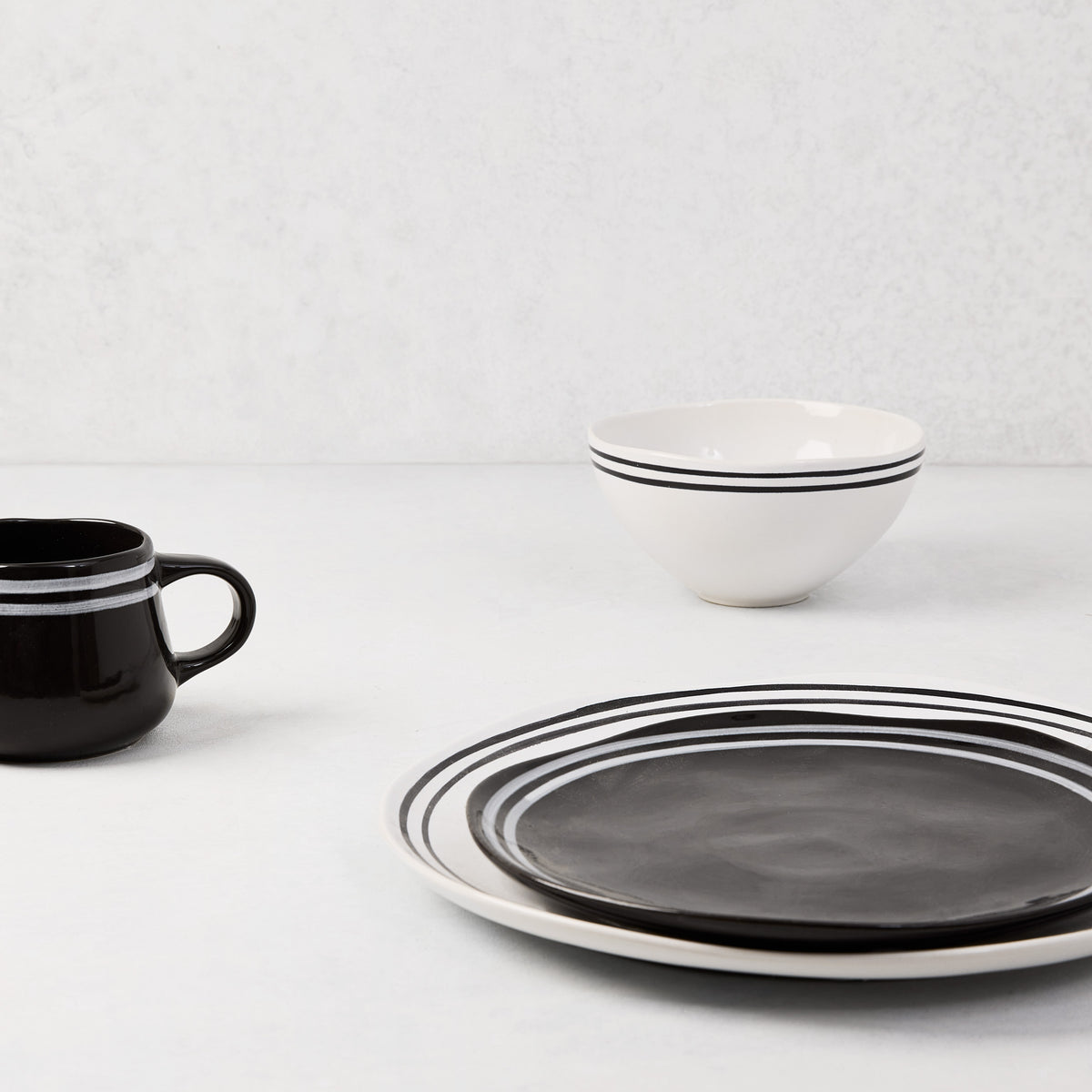 Diane Keaton + Hudson Grace Draft black stoneware salad plate with white double stripes.